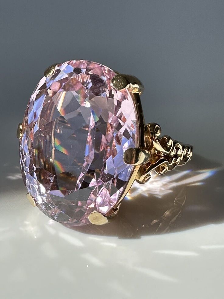 Vintage 40ct Pink Kunzite and 14k Gold Ring. Pretty in Pink! This magnificent Kunzite, weighing a massive 39.9 carats, is perfectly presented in a simple prong setting made of 14k gold with scroll details. Estimated Gemstone weight 39.9 carats Gemstone dimensions 24.5 x 19.25 x 13.3mm 14k gold Weight 18.2 grams Currently Size 9.25 and easily sizeable Note: the color of Kunzite can fade if exposed to strong sunlight for long periods of time. Kunzite Engagement Ring, Mafia Princess, Hand Brooch, Kunzite Ring, Pink Kunzite, Princess Luna, Gold Cocktail Ring, Gold Cocktail, Etsy Gold Ring