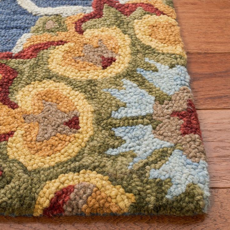 a multicolored area rug with flowers on it