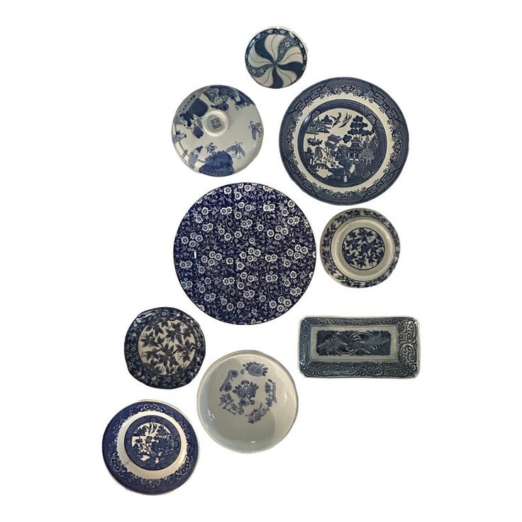 an assortment of blue and white plates with designs on them