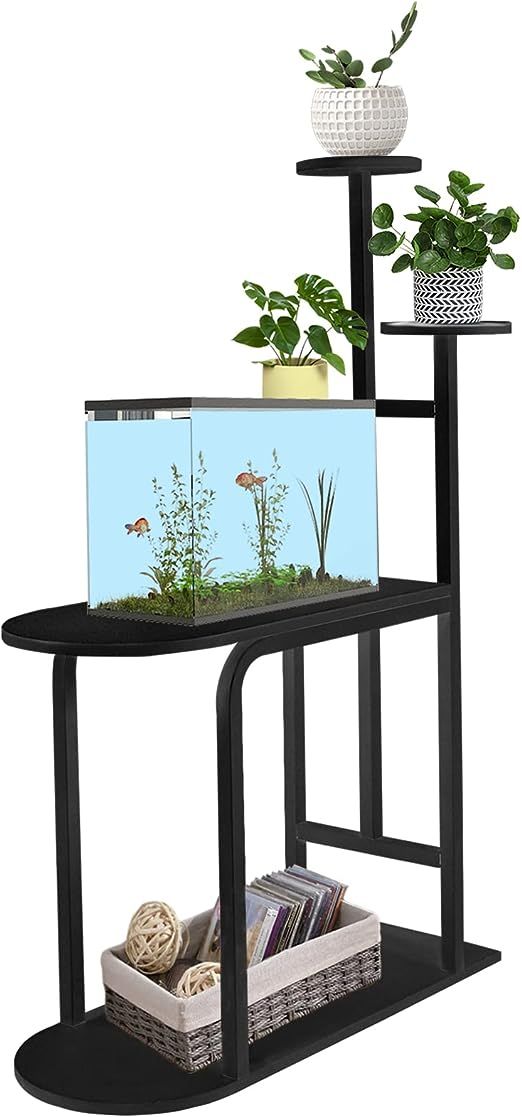 a black shelf with two plants and a fish tank on it's side,