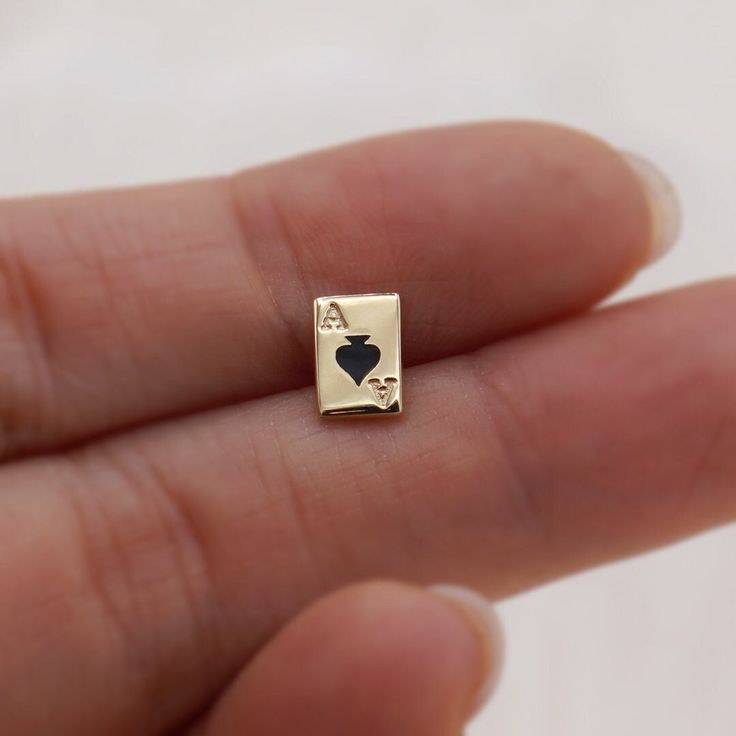 Unique Ace of Spades earrings, quirky playing card stud earrings made in 14k solid gold and black enamel * Stud size: 7x5mm * Material: 14K Solid Yellow Gold. * Sold as One pair.  * Solid gold backings included. ❤️Visit our official website for exclusive new products.      https://elekalonjewelry.com/ ❤️Follow us on Instagram @ elekalonjewelry for the latest projects and much more! ❤️If you have any questions, please feel free to message us. Nerd Earrings, Game Earrings, Card Earrings, Poker Card, Dainty Studs, Earrings Dainty, Earrings Unique, Playing Card, Black Enamel