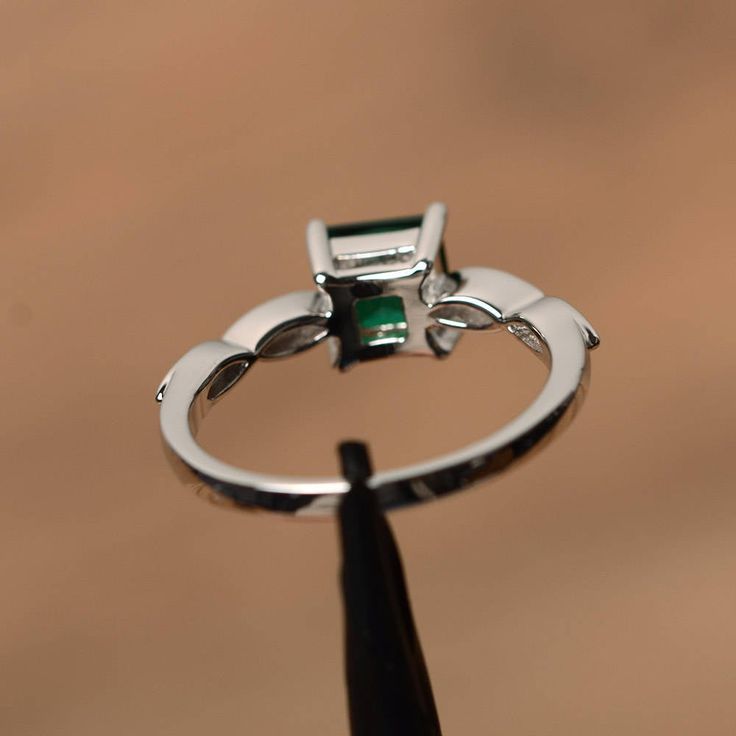 It is a lab emerald ring, princess cut, measures 6mm*6mm, weight about 0.93 cts. The basic metal is sterling silver and plated with rhodium. To change the metal to a solid gold (white/rose) or platinum is also available, please ask for a quotation if you want. You can also go to my shop Home for more elegant rings: https://www.etsy.com/shop/godjewelry?ref=hdr_shop_menu emerald is May birthstone More emerald rings: https://www.etsy.com/shop/godjewelry?ref=seller-platform-mcnav&section_id=2070 Emerald Promise Rings, Ring Princess Cut, Rings Green, Elegant Rings, May Birthstone Rings, Emerald Rings, Birthstone Rings, Rings Sterling Silver, May Birthstone