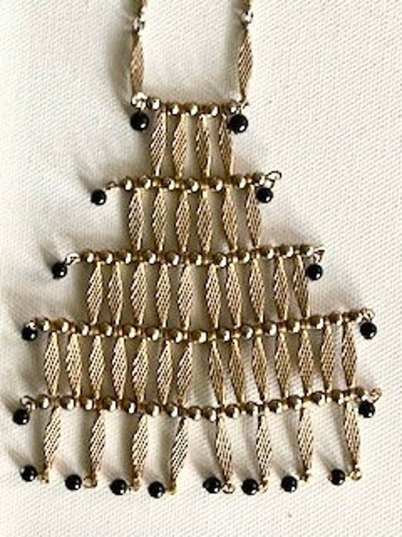 Very Vintage Gold -Tone stations separated by gold vermeil and black beads Centerpiece measures 4 Inches and is graduated from the top . The largest part of the width is 3.5" with a total length of 32". The clasp is a simple spring ring, however this will fit over the neck easily. Gold Beaded Necklaces With Black Beads For Evening, Gold Necklaces With Black Beads For Party, Gold Beaded Necklace With Black Beads For Evening, Formal Black Jewelry With Gold Beads, Black Jewelry With Gold Beads For Formal Occasions, Gold Metal Beaded Necklaces With Black Beads, Gold Metal Beaded Necklace With Black Beads, Gold Metal Necklace With Black Beads, Gold Multi-strand Necklace With Black Beads