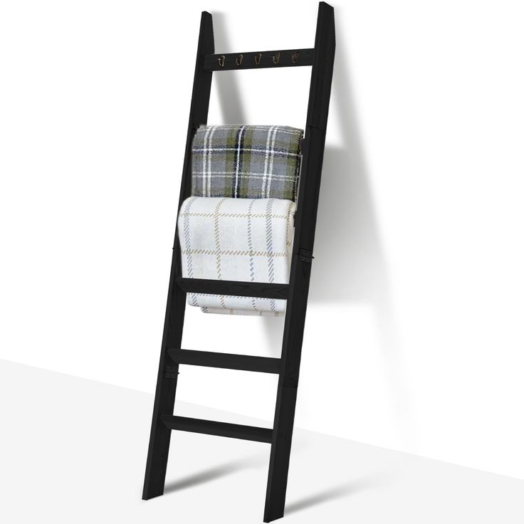 a ladder leaning against a wall with a plaid blanket on it's back end