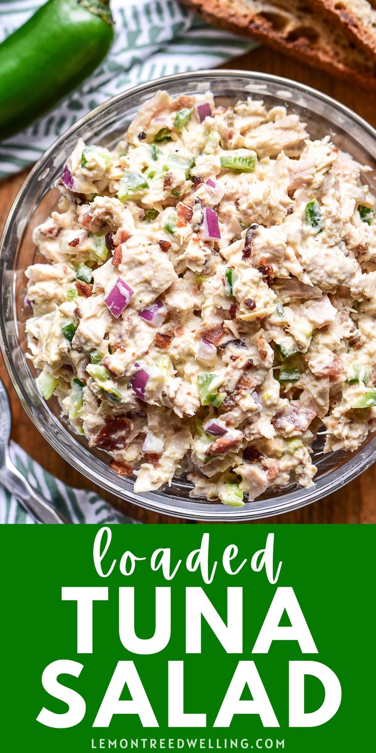 loaded tuna salad in a glass bowl with green peppers on the side