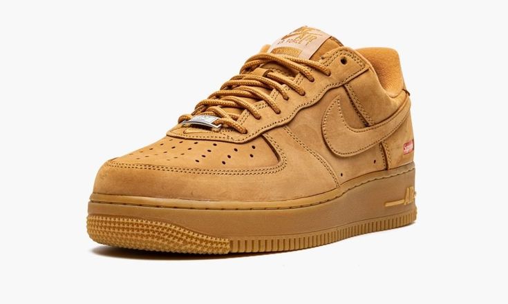 The Supreme x Nike Air Force 1 Low “Wheat” is a Fall/Winter 2021 collaboration between the “World Famous” streetwear brand and Nike on a classic, fall and winter colorway of the retro basketball shoe.  The “Wheat” Air Force 1 is designed and inspired by iconic cold weather footwear staples in New York City, particularly construction boots.  Supreme’s version of the colorway stays true to the original “Wheat” style, save for the added small red Box Logo on the heel.  The entire upper, including t Wheat Air Force 1, Supreme Store, Tenis Air Force, Supreme X Nike, Supreme Box Logo, Retro Basketball Shoes, Air Jordan 9, Custom Air Force 1, Jordan 8