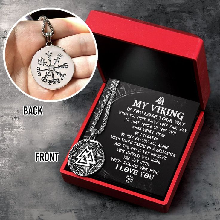 a hand holding a compass necklace in a red box with the words, i love you