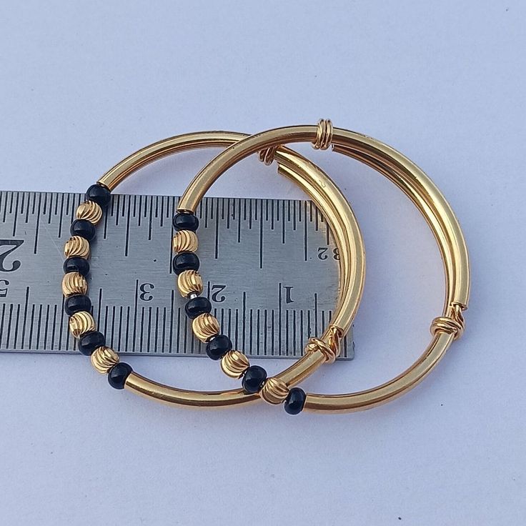 925 Sterling Silver Gold Polished Traditional Nazariya Baby Bangles Baby Kade Black & Silver Beads Silver Gold Polished Bangles  Size 1 : 0 - 2 Year Baby, Weight : 12 Gram Size 2 : 2 - 5 Year Baby, Weight : 14 Gram See More Gemstone :  https://www.etsy.com/in-en/shop/silveriumjewels P R O D U C T I O N ~ T I M E S ~ Every single item we sell is handcrafted to order with care. :) Please check individual items and our policies page for the most recent production updates. S H I P P I N G ~ We offer Stackable Bangle With Round Beads For Gift, Stackable Bangle With Round Beads As Gift, Adjustable Gold Jewelry For Birthday, Gold Stackable Beaded Bracelets For Birthday, Gold Bangle Bracelet For Birthday, Gold Stackable Bracelets For Birthday, Adjustable Round Gold Bracelet Stackable, Gold Bead Bracelet Gift, Handmade Gold Bracelets For Birthday