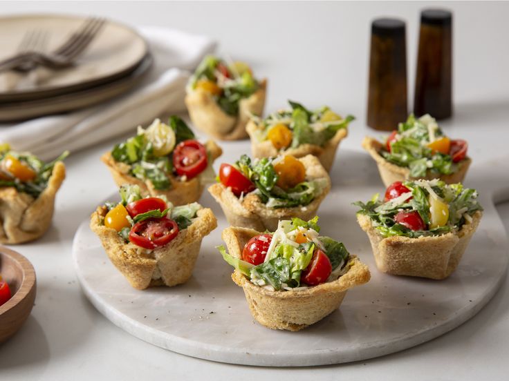 small appetizers are arranged on a white plate