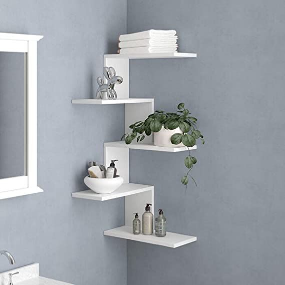 a bathroom with blue walls and white shelving units on the wall next to a sink