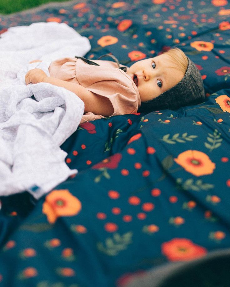 a baby doll laying on top of a blanket