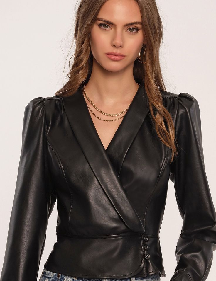 The Palma Top is made of our new vegan leather - soft, luxe, and looks just like the real thing. It's fitted with a surplice bodice with a foldover collar and a peplum silhouette.[split]Vegan leatherSlim fitSurplice bodice with buttonsPeplum shape, shawl collar50% Polyester / 50% PolyurethaneLength: 21" from high point of shoulderMeasurements from Size S Chic Fitted Faux Leather Outerwear, Fitted Faux Leather Outerwear For Night Out, Chic Fitted V-neck Outerwear, Fitted Faux Leather Outerwear For Party, Fitted Faux Leather Evening Outerwear, Chic Fitted Outerwear For Date Night, Fitted Faux Leather Outerwear For Evening, Elegant Faux Leather Outerwear For Night Out, Fitted Faux Leather Outerwear For Evenings