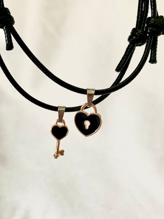 Couple’s bracelet set with a heart-shaped charm and a key charm Black Jewelry With Removable Charms For Gifts, Valentine's Day Key Jewelry Gift, Adjustable Key Bracelets As Gift, Lock Bracelet Jewelry Gift, Lock Jewelry For Valentine's Day Gift, Heart-shaped Lock Jewelry For Valentine's Day, Metal Jewelry With Keys For Gifts, Valentine's Day Heart Pendant Jewelry With Two Keys, Valentine's Day Gift Jewelry With Lock