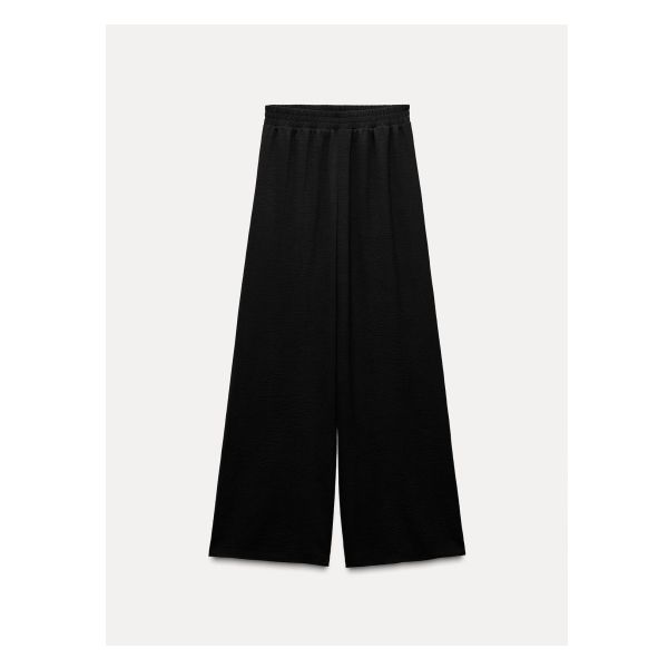 Flowy pants with a mid waist and wide elastic waistband. Wide leg. Versatile Baggy Sweatpants With Elastic Waistband, Elegant Wide-leg Sweatpants With Elastic Waistband, Baggy High-waisted Sweatpants With Elastic Waistband, Baggy High Waist Wide Leg Pants With Elastic Waistband, Stretch High-waisted Pants With Elastic Side Panels, Spring Baggy Pants With Ribbed Waistband, Baggy High-waisted Pants With Elastic Waistband, Versatile Baggy Wide-leg Pants, Baggy Wide-leg Pants With Versatile Style