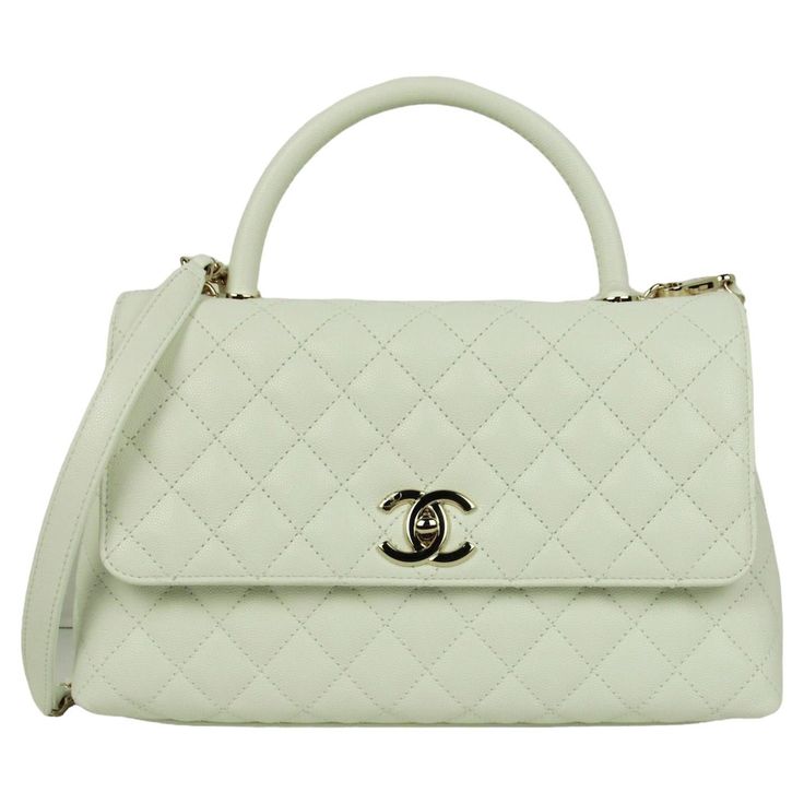 Chanel White Caviar Leather Quilted Small Coco Handle Flap Bag Made In: Italy Year of Production: 2023 Color: White Hardware: Pale goldtone Materials: Caviar leather Lining: Leather Closure/Opening: Flap top with CC twist lock Exterior Pockets: Back patch pocket Interior Pockets: Two compartments separated by zipper pocket, patch pockets, and a central zipper compartment.  Exterior Condition: Excellent  Interior Condition:  Excellent Includes: Dustbag, tag Measurements: 11.25"L x 7"H x 4.5"D Handle Drop: 3.25" Strap Drop: 19.25" Dior New Look, Sportswear Store, Vintage Chanel Bag, White Hardware, Coco Handle, Chanel Suit, Chanel White, 2023 Color, Chanel Brand