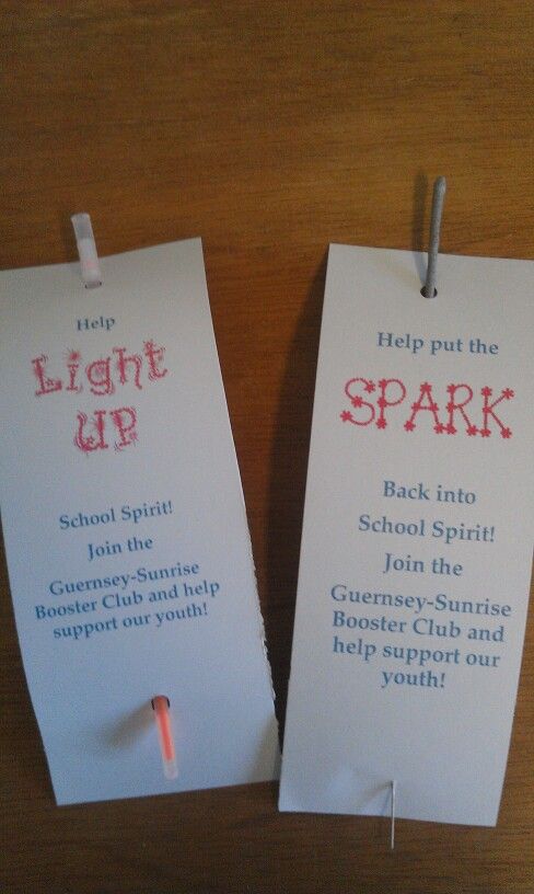 two white tags with words on them that say light up and spark in the dark