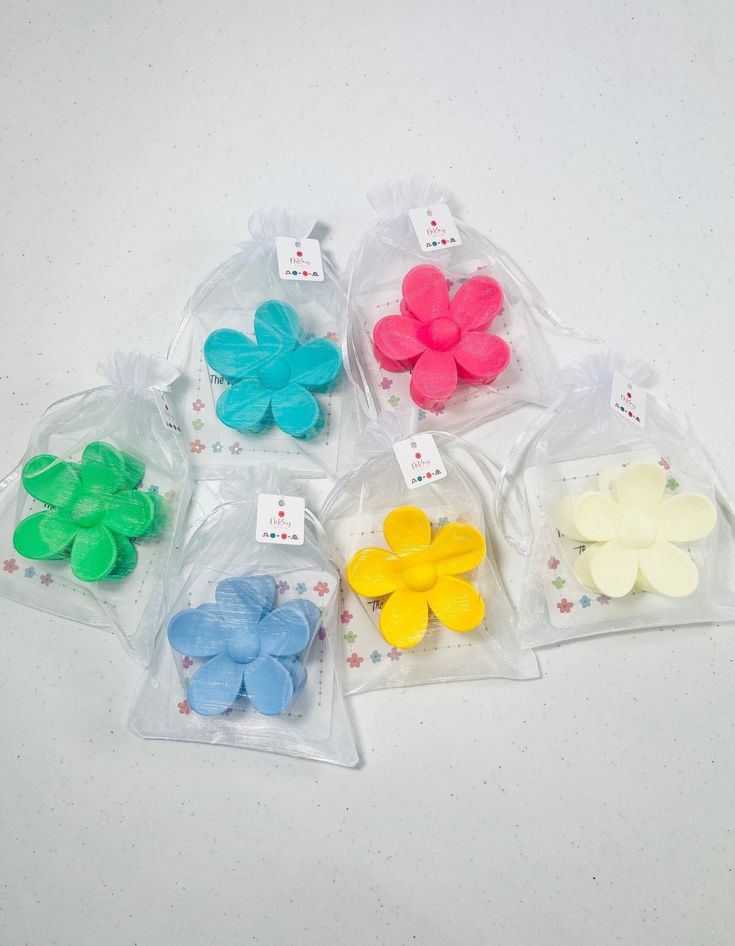 small plastic flowers in bags on a table