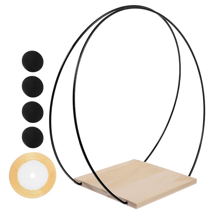 a wooden stand with three black circles on it and one white circle in the middle