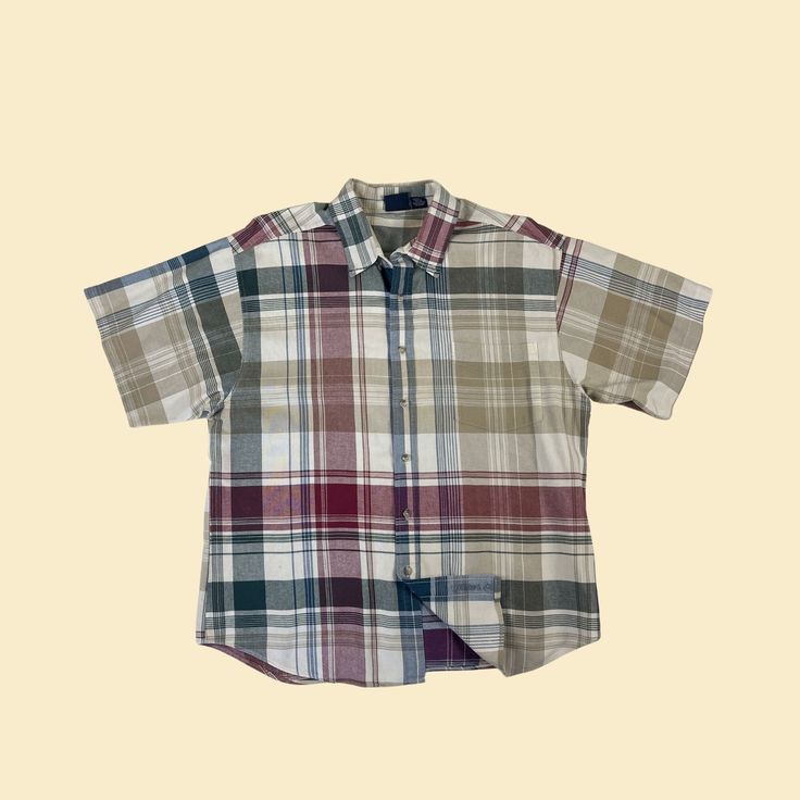 Vintage men's plaid button down short sleeve shirt, manufactured ca. 1980s/1990s by Bon Homme. Features a collar and front pocket, and a relatively lightweight fabric. Size L.   - Time Period: 1980s / 1990s  - Brand: Bon Homme  - Size: L  - Colors: Blue, red, beige, off white  - Materials: 100% cotton  - Made in: USA  - Condition: In good, vintage condition with a minor marking on the bottom left, and writing one the inside hem (i.e., prior owner wrote in their name). Measurements:   - Armpit to Relaxed Fit Plaid Short Sleeve Button-up Shirt, Plaid Relaxed Fit Short Sleeve Button-up Shirt, Classic Plaid Cotton Short Sleeve Shirt, Plaid Short Sleeve Button-up Shirt, Plaid Button-up Short Sleeve Shirt, Classic Plaid Short Sleeve Shirt For Summer, Classic Cotton Short Sleeve Plaid Shirt, Classic Short Sleeve Cotton Flannel Shirt, Plaid Cotton Short Sleeve Shirt With Button Closure