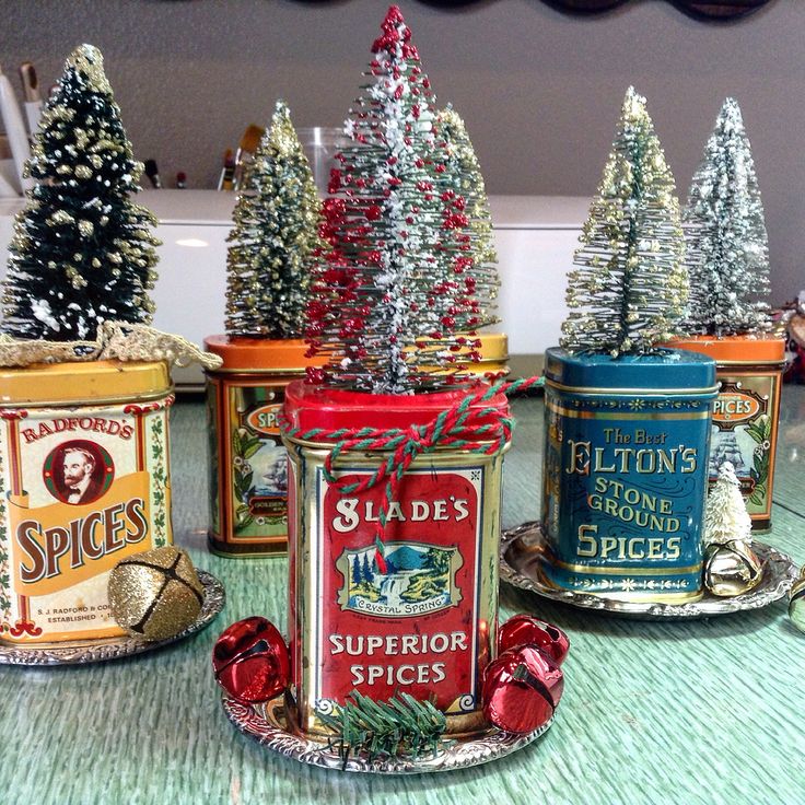 three tin canisters with christmas trees in them sitting on a table next to each other