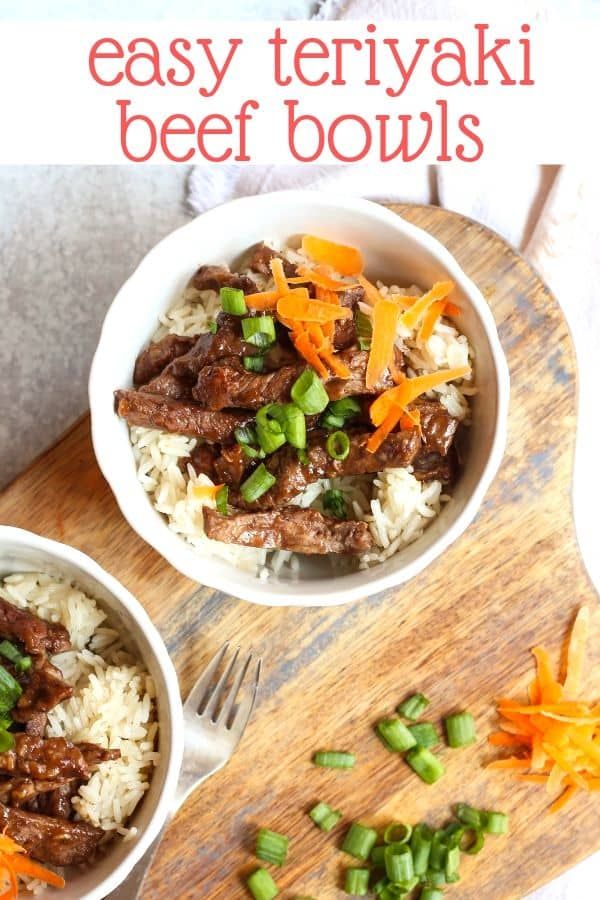 two bowls filled with beef and rice on top of a wooden cutting board next to green onions