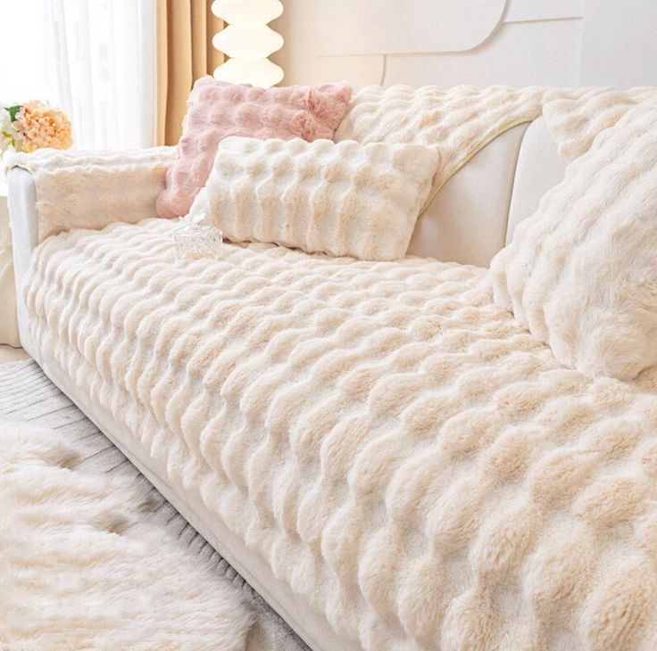 a white couch with several pillows on it