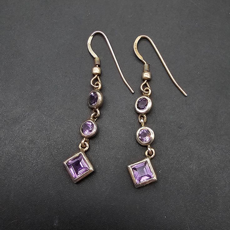 These amethyst and sterling earrings are for pierced ears and feature faceted amethyst stones set in sterling silver and measure 1.75" x .2" They are signed 925 on the earring hook Purple Stamped 925 Earrings For Anniversary, Nickel Free Amethyst Earrings For Anniversary, Amethyst Dangle Earrings For Anniversary, Purple Dangle Jewelry Stamped 925, Lavender Sterling Silver Earrings For Pierced Ears, Purple Faceted Earrings For Anniversary, Lavender Drop Earrings In Sterling Silver, Purple Sterling Silver Drop Earrings, Amethyst Dangle Earrings Stamped 925