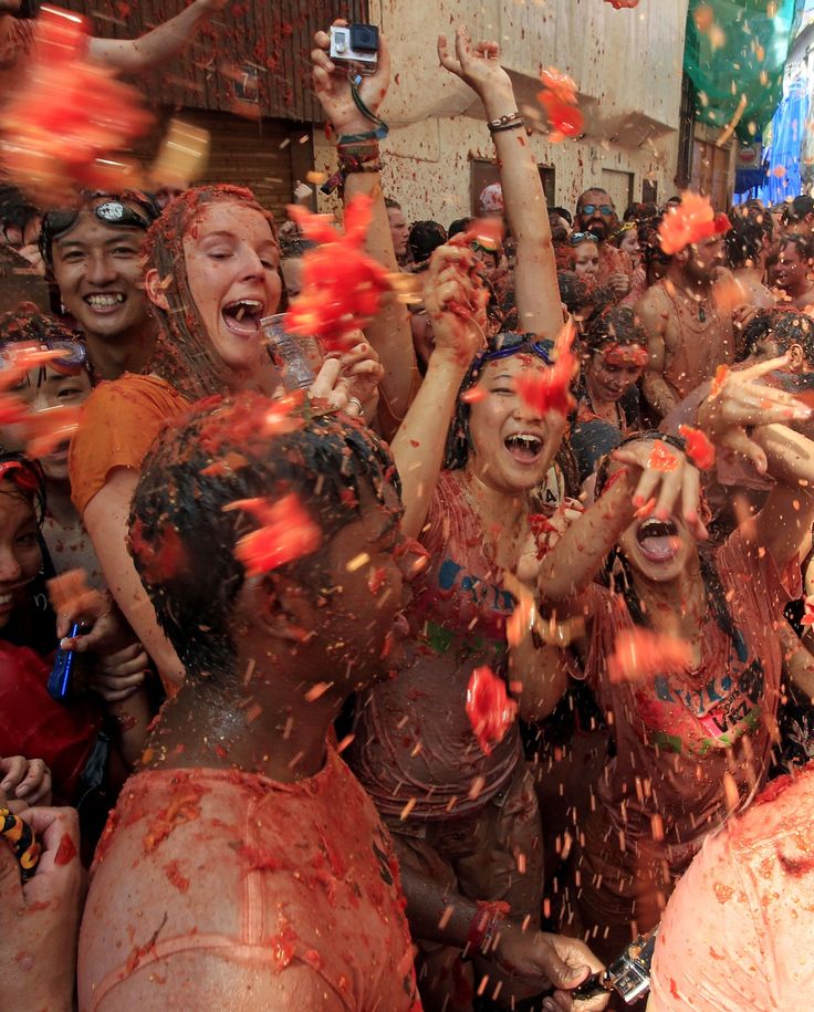 many people are covered in colored powder and throwing confetti on them as they celebrate