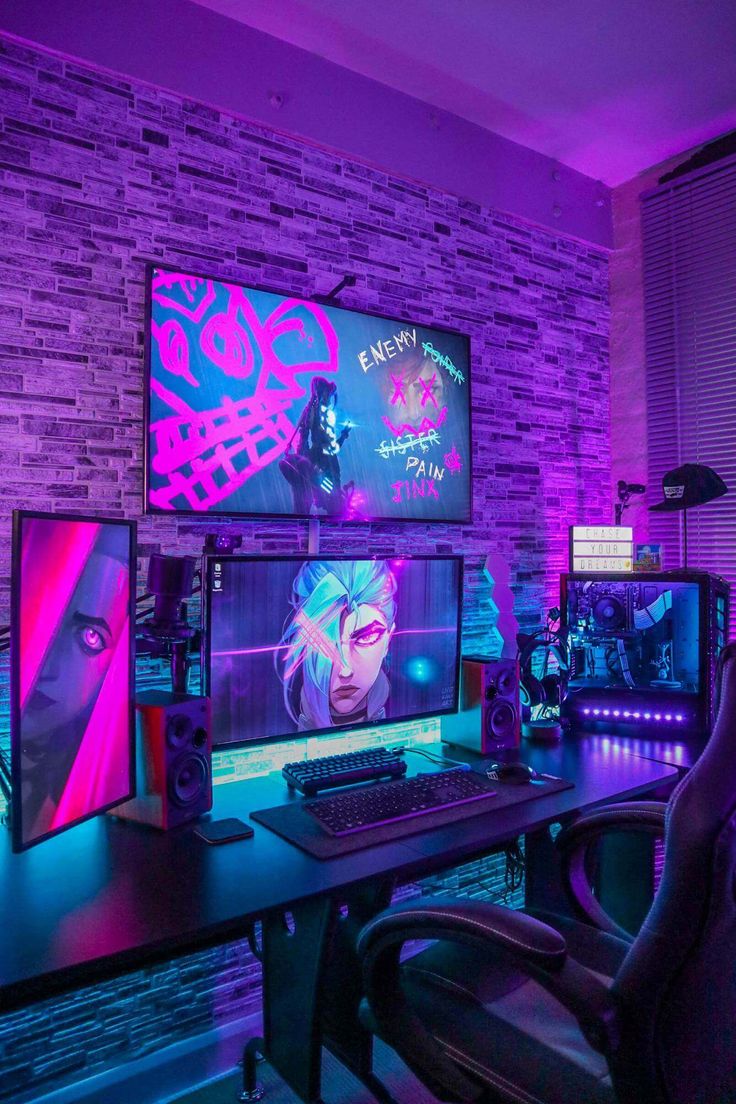 two computer monitors sitting next to each other on top of a desk in front of a brick wall