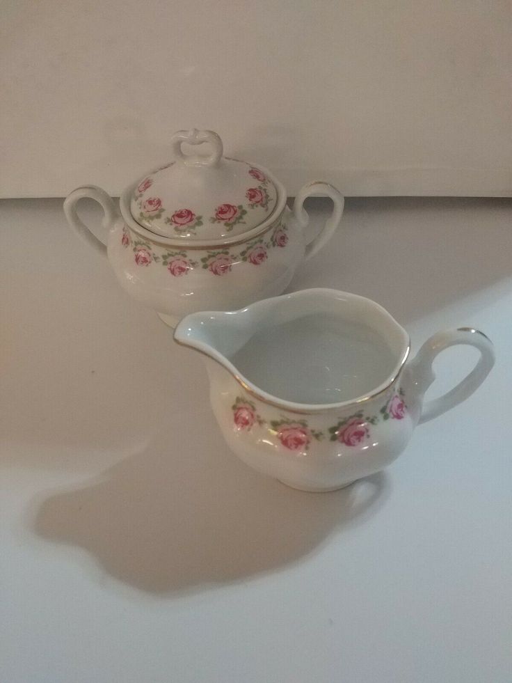 two white dishes with pink flowers on them