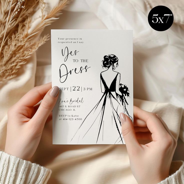 a woman holding up a wedding card with the word yes to the dress on it