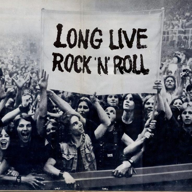 a group of people holding up a sign that says long live rock'n'roll