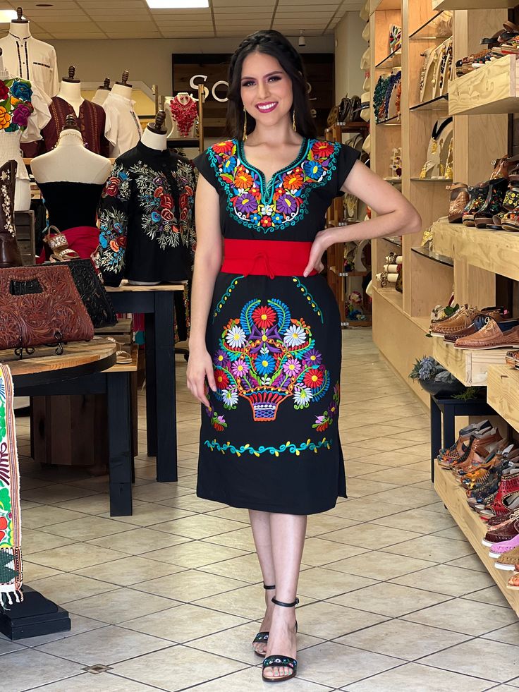 -This Beautiful Long Mexican Colorful Floral Dress is the perfect dress for a fun night out or a special event. -It is full of colorful embroidered flowers and has some crocheted details. -This dress has ties on the back in order to adjust the fit. - You can purchase the dress either with or without the belt. Please note: The accesories shown with this dress may purchased as well and Can be found in this links Earrings:https://www.etsy.com/es/listing/855938626/aretes-mexicanos-de-filigrana-arete Fitted Black Dress For Fiesta, Traditional Black Fiesta Dress, Traditional Black Dress For Fiesta, Fitted Traditional Dress For Fiesta, Black Short Sleeve Dress For Fiesta, Embroidered Short Sleeve Fiesta Dress, Fiesta Embroidered Short Sleeve Dresses, Fitted Floral Embroidery Dress For Fiesta, Fitted Dress With Multicolor Embroidery For Fiesta