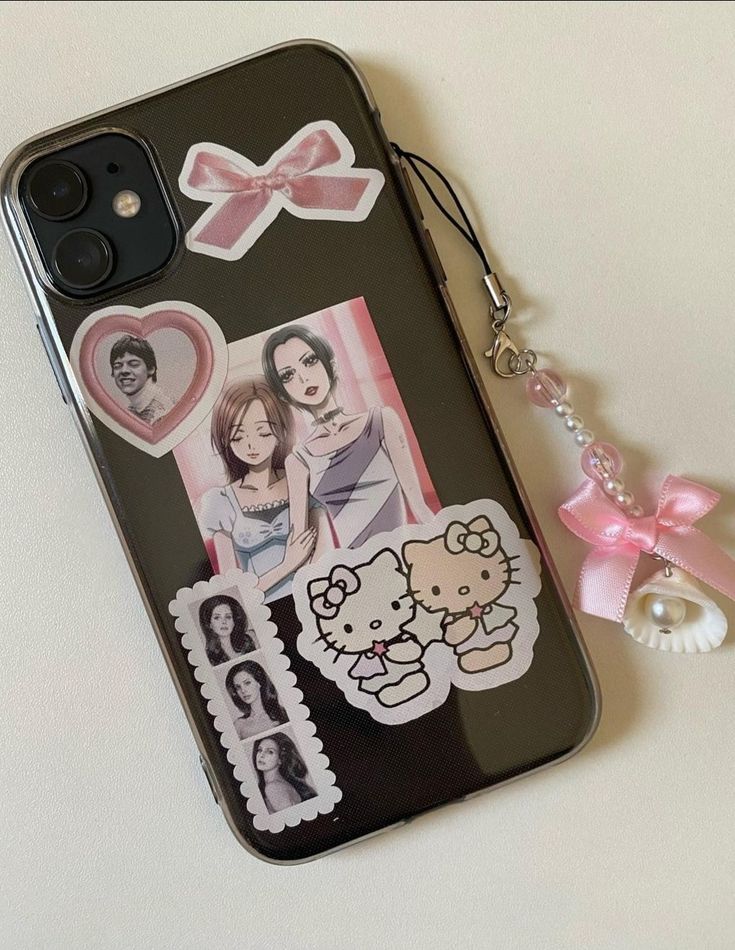 a cell phone case with an image of two women and a hello kitty keychain