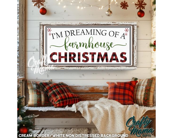 a christmas sign hanging on the side of a wall next to a bench with pillows and blankets