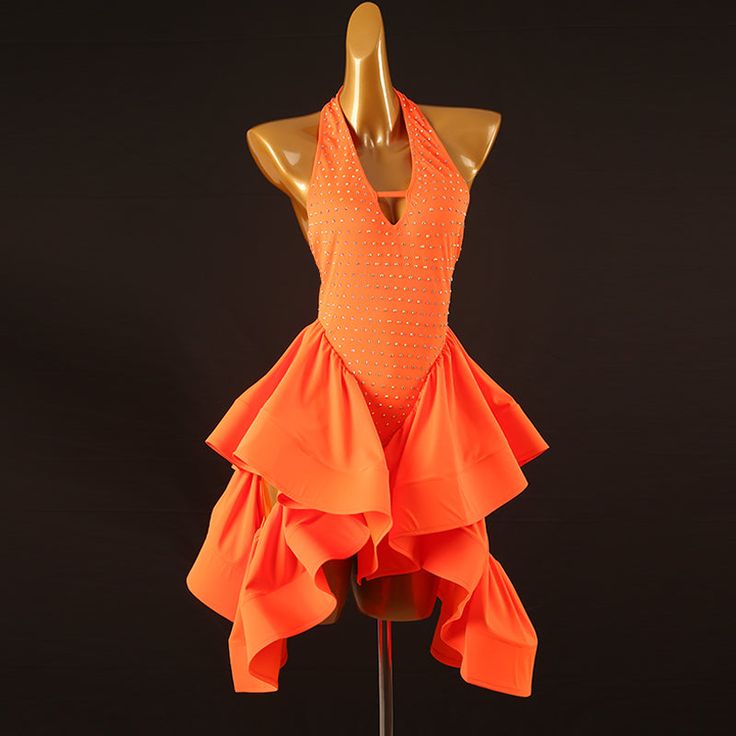 a mannequin with an orange dress on display