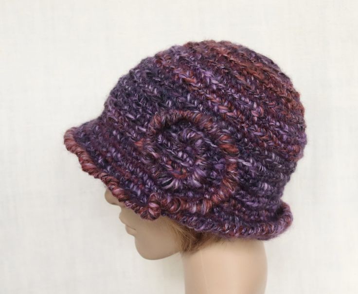 Crochet purple with multicolor (rust brown, lilac, dark grey) winter hat for women. Materials - different yarns with different chemical composition. Common fiber content : 30 % sheep wool, 7 % alpaca wool. 7 % silk, 1 % viscose, 46 % acrylic, 2 % polyamide. Size 57 - 60 cm (22 1/2 - 23 1/2 in.). Brimmed Yarn Cloche Hat For Winter, Yarn Brimmed Cloche Hat For Winter, Winter Yarn Brimmed Cloche Hat, Winter Yarn Cloche Hat With Brim, Purple Beanie For Fall, Purple Winter Hat With Curved Brim, Purple Yarn Cap, Purple Hand Knitted Crochet Cap, Purple Hand-knitted Crochet Cap