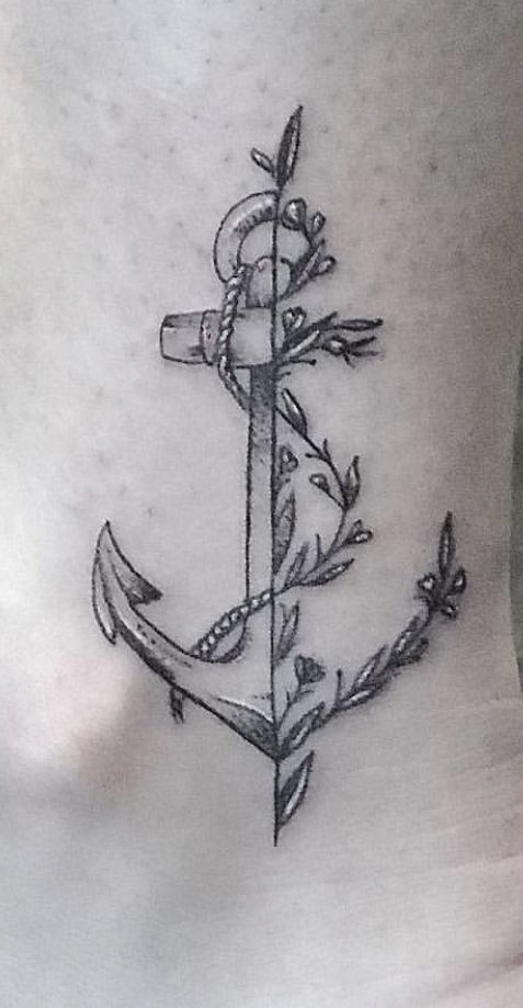 an anchor tattoo on the side of a woman's stomach