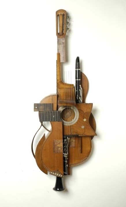 a wooden guitar hanging on the wall