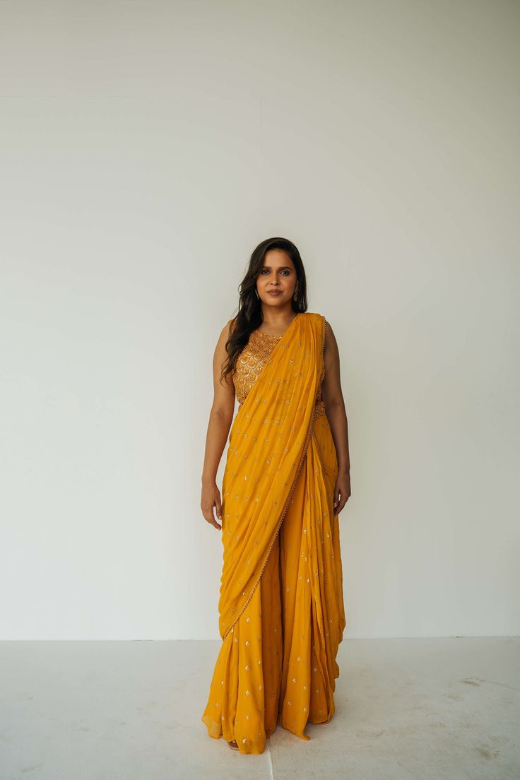 The Rani Palazzo 2.0 gives you the drape of a saree without any hassle. Featuring an all over embroidery on the pants and drape, and the blouse includes sequin work with accent beading. For a custom color order, please email hello@sani.co. For the marigold piece, check out the first outfit in this TikTok video (starts at about 0:09). For the navy piece, check out the second outfit in this TikTok video (starts at about 0:22). All Over Embroidery, Anarkali Gown, Tiktok Video, Blouse Length, Palazzo Pants, Anarkali, High Waisted Pants, Fabric Care, Custom Color