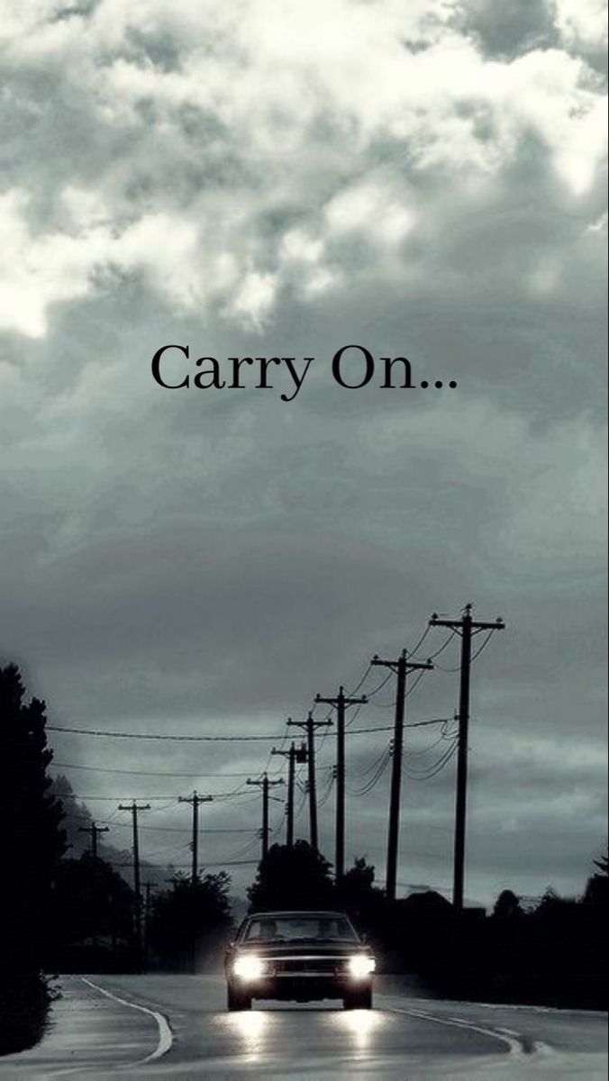 a car is driving down the road with power lines in the background that says, carry on