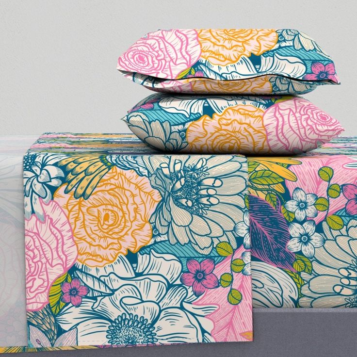 three sheets are stacked on top of each other, with colorful flowers all over them