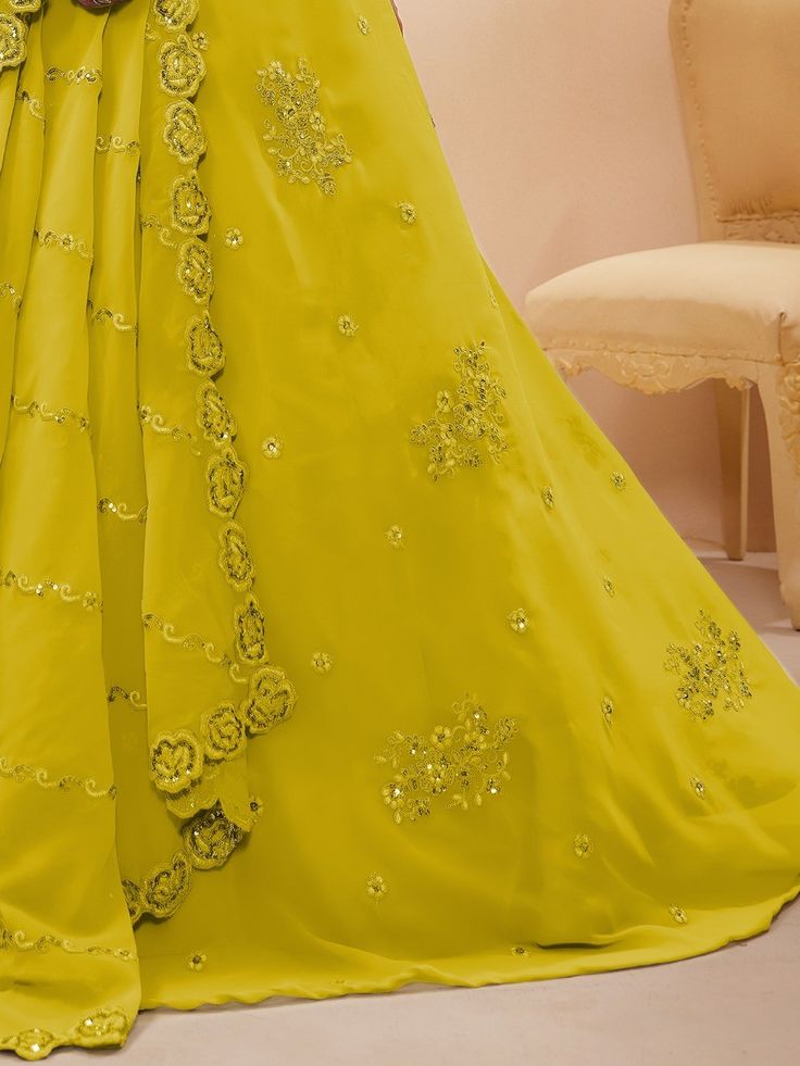 Introducing our adorable neon yellow sequins georgette wedding wear lehenga choli, a vibrant and stylish outfit that is perfect for any special occasion. This exquisite piece is made from high-quality georgette material in a stunning neon yellow color. It features intricate dori work, glitter sequin work, and embroidery work, adding a touch of elegance and glamour to the ensemble.
The set includes a matching georgette choli that is adorned with the same dori work, glitter sequin work, and embroi Embellished Georgette Lehenga Maxi Length, Embellished Georgette Lehenga In Maxi Length, Designer Yellow Georgette Gown, Party Wear Embellished Georgette Lehenga, Embellished Party Wear Lehenga In Georgette, Embellished Georgette Lehenga For Party, Elegant Yellow Georgette Lehenga, Elegant Yellow Lehenga In Georgette, Festive Yellow Embellished Anarkali Set