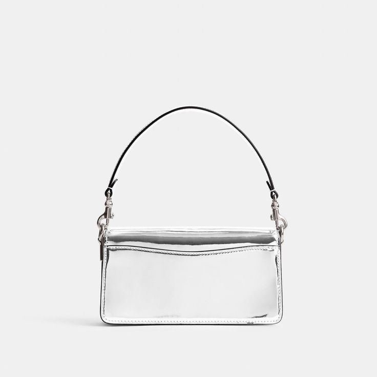 A modern take on an archival 1970s Coach design our structured Tabby shoulder bag is crafted of lustrous mirror metallic leather. Smaller than the 26 the petite 20 features two detachable straps to carry by hand style as a short shoulder bag or wear crossbody. It’s finished with our Signature hardware for an iconic touch. | Coach Tabby Shoulder Bag 20 In Metallic - Women's - Silver/silver Silver Shoulder Bag With Detachable Strap For Formal Occasions, Formal Silver Shoulder Bag With Detachable Strap, Modern Silver Shoulder Bag For Formal Events, Party Shoulder Bag Satchel With Palladium Hardware, Classic Silver Shoulder Bag With Detachable Strap, Silver Satchel Evening Bag, Modern Coach Clutch Shoulder Bag, Metallic Clutch Shoulder Bag For Formal Occasions, Modern Party Satchel Box Bag