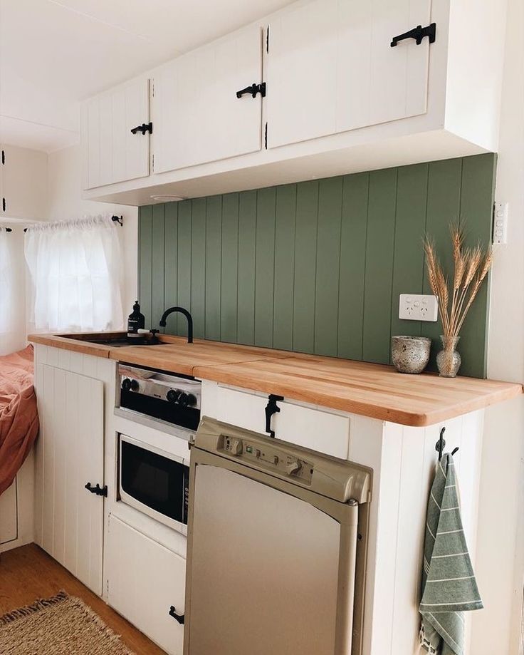 a kitchen with an oven, dishwasher and sink