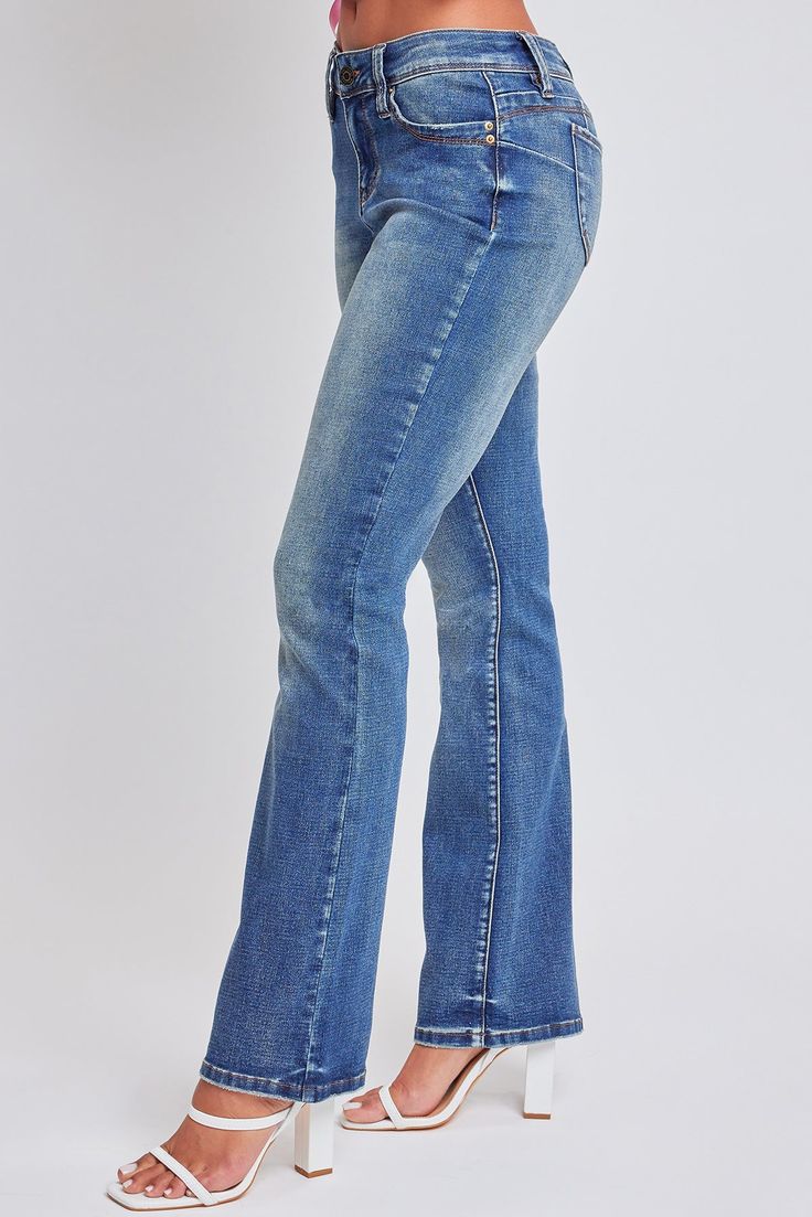 Slide into this denim like he does your DMs. Our Women’s WannaBettaButt Mid Rise Boot Cut Jeans made with recycled fibers will have you feeling too hot to handle. Part of our WannaBettaButt collection, these pants feature our famous heart-shaped stitching and perfectly placed pockets for a contouring look that lifts and enhances your natural curves. Constructed with midweight denim, this mid-waisted jean is fitted hip to knee with a subtle boot flare at the hem. Made with recycled material because earth is bae <3 Style with a baby tee and cowboy boots for a rocking good time! Product Details - Mid-Rise- Front Zip Fly with Single Button Closure - Classic 5-Pocket Construction - Boot Cut - Full LengthSize & Fit (based on size 5)- Inseam: 33”- Rise: 9”- Leg Opening: 18”Machine wash cold, sepa Mid Rise Bootcut Jeans, Too Hot To Handle, Mid Waist Jeans, Ymi Jeans, Natural Curves, Boot Cut Jeans, Cut Jeans, Baby Tee, Medium Blue