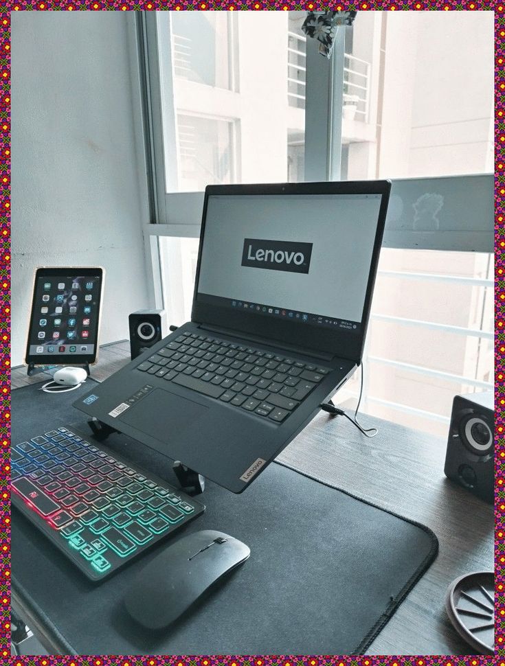 an open laptop computer sitting on top of a desk next to a mouse and keyboard