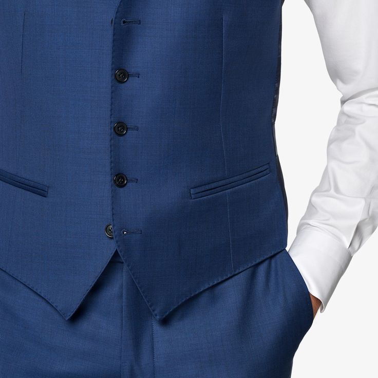 Mid blue waistcoat with a slim fit, featuring a V-neck collar, jetted pockets, single-breasted 5-button closure, and a rear cinch for an adjustable fit. Purple Waistcoat, Blue Waistcoat, Navy Tuxedos, Double Breasted Waistcoat, Men's Waistcoat, Wool Flannel, Black Tuxedo, Neck Collar, Fashion Advice