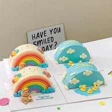 there are three cakes with rainbows on the top and one has a teddy bear