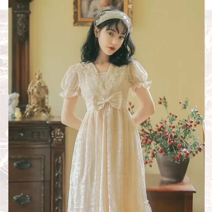 Dodobye French Palace Style Princess Dress for Women First Love Bow Lace Sweet Kawaii Dresses Romantic Retro Summer DressSPECIFICATIONSBrand Name: DodobyeElasticity: Non StrechSleeve Style: puff sleeveFabric Type: LacePattern Type: SolidFit Type: Regulai FitSilhouette: A-LINENeckline: V-NeckDecoration: BOWStyle: SweetDresses Length: Mid-CalfMaterial: COTTONAge: MIDDLE AGEOrigin: Mainland US(Origin)CN: GuangdongSeason: SummerClosure Type: PulloverType: regularMaterial Composition: synthetic fiber White Short Sleeve Kawaii Dress, Kawaii Summer Dress With Lace Trim, Kawaii Style Short Sleeve Dresses, Cute Cream Dress With Doll Collar, Sweet Cream Short Sleeve Dress, Cute White Vintage Dress With Doll Collar, Cute White Vintage Dress With Lace Trim, White Kawaii Dress With Lace Trim, Sweet Short Sleeve Wedding Dress